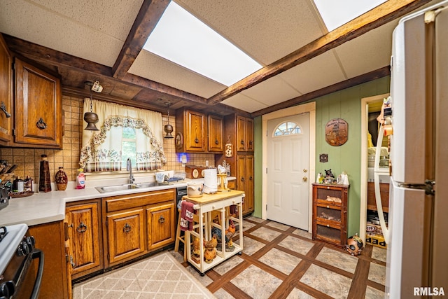 509 W Mcclure Ave, Peoria, IL 61604 - kitchen featuring backsplash, brown cabinetry, inlaid floor details, and light countertops