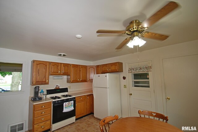 4 Alexander Ln, Bartonville, IL 61607 - kitchen featuring gas stove, freestanding refrigerator, light countertops, brown cabinetry, and ceiling fan