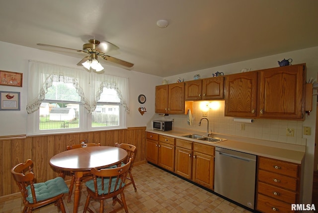 4 Alexander Ln, Bartonville, IL 61607 - kitchen with stainless steel appliances, a wainscoted wall, brown cabinetry, ceiling fan, and light countertops