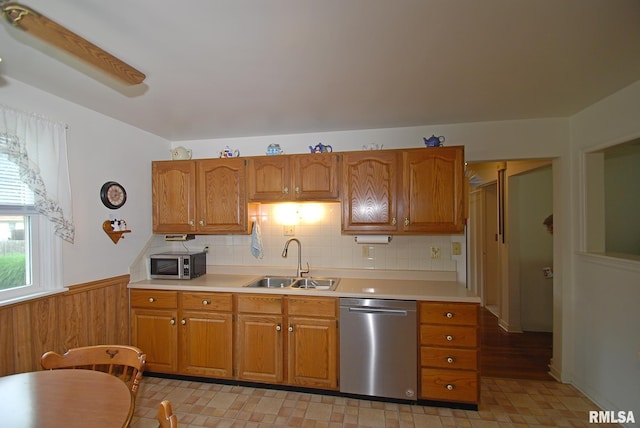 4 Alexander Ln, Bartonville, IL 61607 - kitchen featuring stainless steel appliances, light countertops, wainscoting, brown cabinets, and wood walls