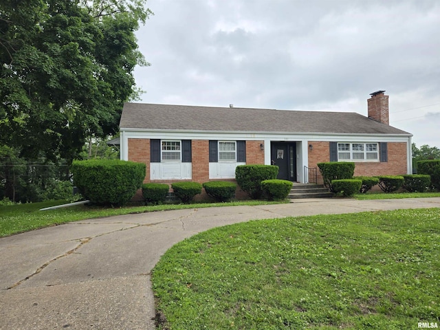 301 N Louise St, La Harpe, IL 61450 - ranch-style home with brick siding, a front yard, a chimney, and roof with shingles