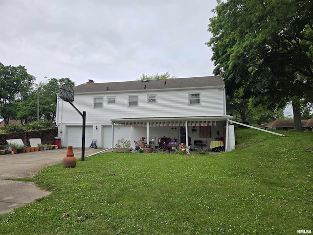 301 N Louise St, La Harpe, IL 61450 - rear view of house with an attached garage, a lawn, and concrete driveway