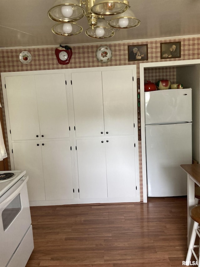 301 N Louise St, La Harpe, IL 61450 - kitchen featuring white appliances, dark wood-style floors, and white cabinets