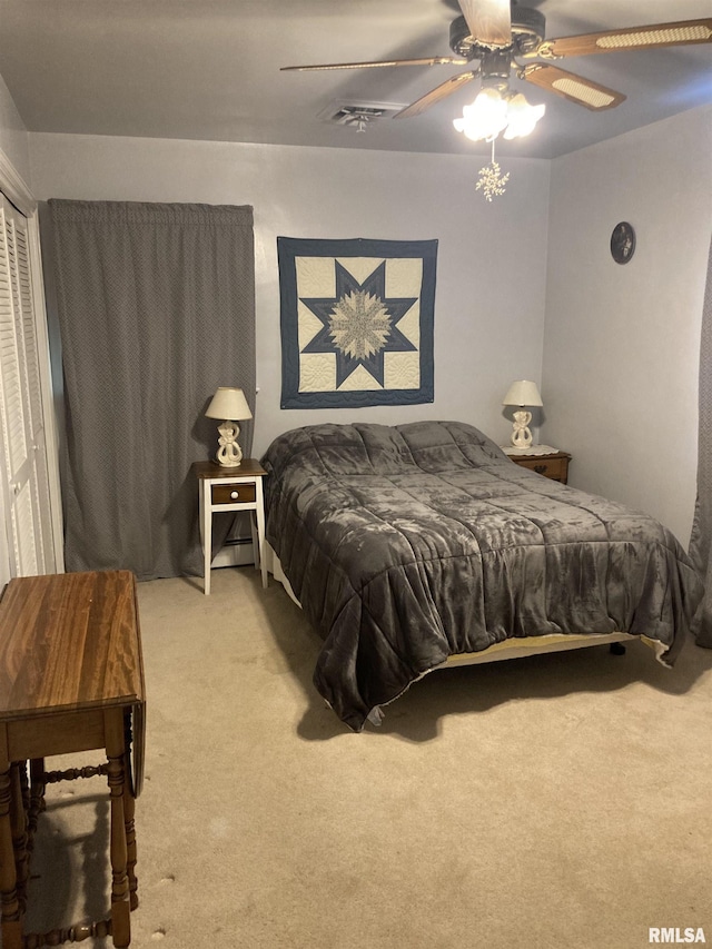 301 N Louise St, La Harpe, IL 61450 - bedroom featuring light colored carpet, ceiling fan, and a closet