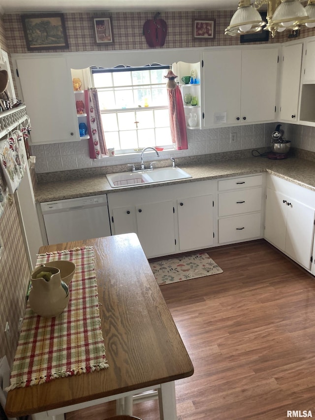 301 N Louise St, La Harpe, IL 61450 - kitchen with white dishwasher, wood finished floors, white cabinetry, backsplash, and open shelves