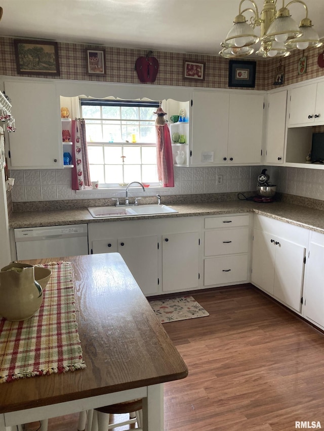 301 N Louise St, La Harpe, IL 61450 - kitchen featuring wood finished floors, dishwasher, open shelves, white cabinetry, and backsplash