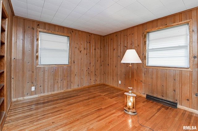 113 Highview Ter, East Peoria, IL 61611 - spare room featuring a baseboard radiator, hardwood / wood-style floors, and wood walls