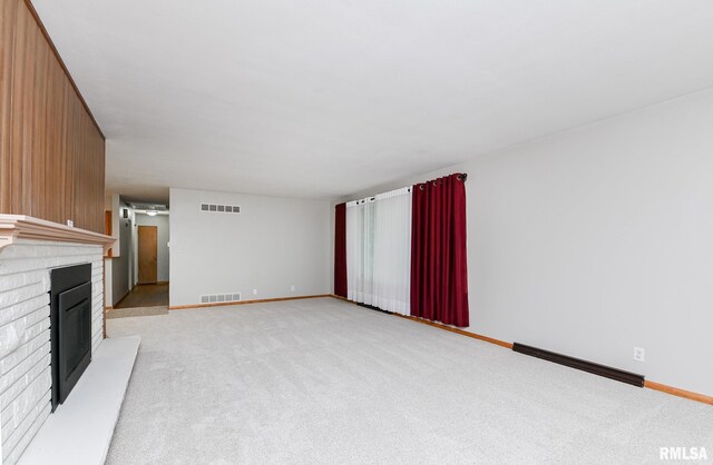 113 Highview Ter, East Peoria, IL 61611 - unfurnished living room with light carpet, a brick fireplace, and a baseboard heating unit