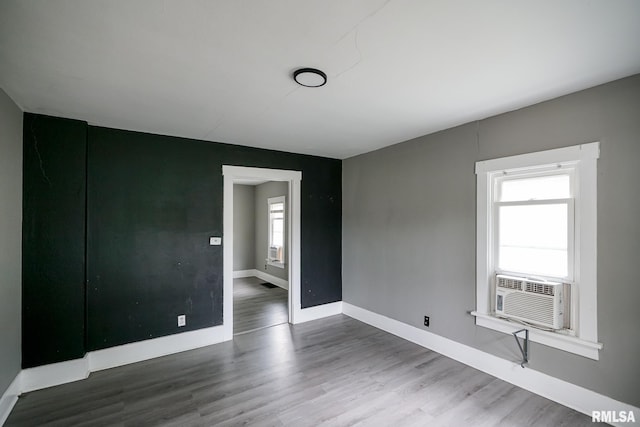 409 E Embert Pl, Peoria, IL 61603 - unfurnished room featuring wood finished floors and cooling unit