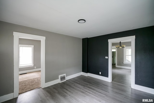 409 E Embert Pl, Peoria, IL 61603 - spare room with a chandelier and wood finished floors