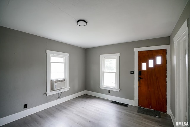 409 E Embert Pl, Peoria, IL 61603 - foyer entrance with plenty of natural light, cooling unit, and wood finished floors