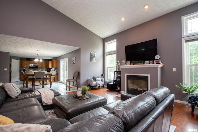 116 Field Ct, East Peoria, IL 61611 - living room featuring a glass covered fireplace, wood finished floors, recessed lighting, and high vaulted ceiling