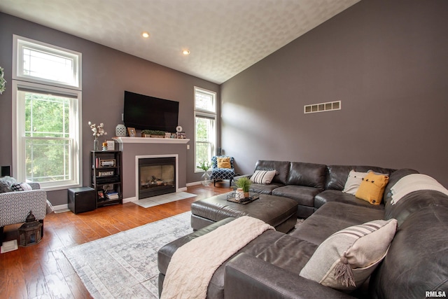 116 Field Ct, East Peoria, IL 61611 - living room featuring hardwood / wood-style flooring, recessed lighting, a fireplace with flush hearth, and high vaulted ceiling