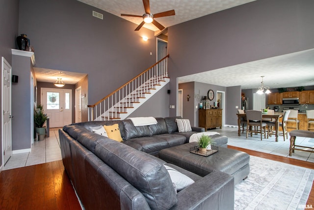 116 Field Ct, East Peoria, IL 61611 - living area with high vaulted ceiling, stairway, a ceiling fan, and light wood-type flooring