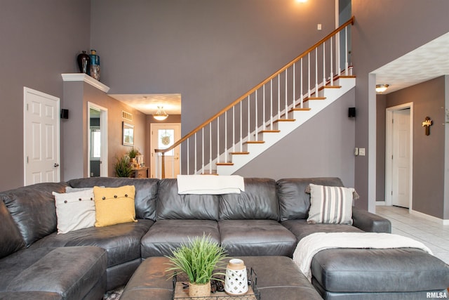 116 Field Ct, East Peoria, IL 61611 - living area with light tile patterned flooring, stairs, and a high ceiling