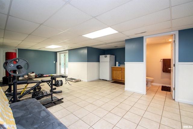 116 Field Ct, East Peoria, IL 61611 - exercise area with a wainscoted wall, a paneled ceiling, and light tile patterned floors