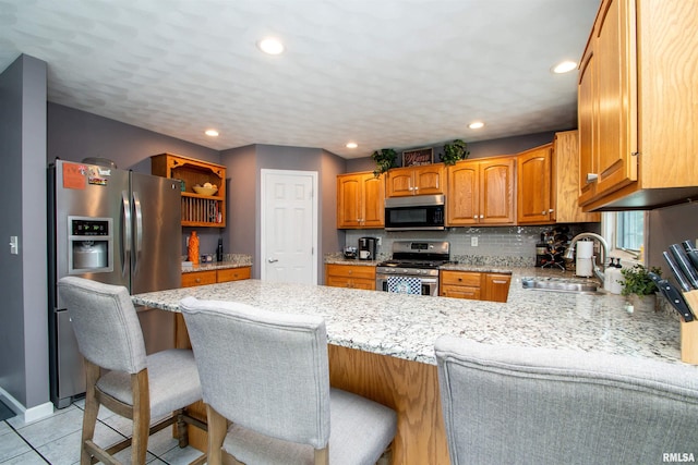 116 Field Ct, East Peoria, IL 61611 - kitchen with stainless steel appliances, a peninsula, open shelves, light stone countertops, and light tile patterned flooring