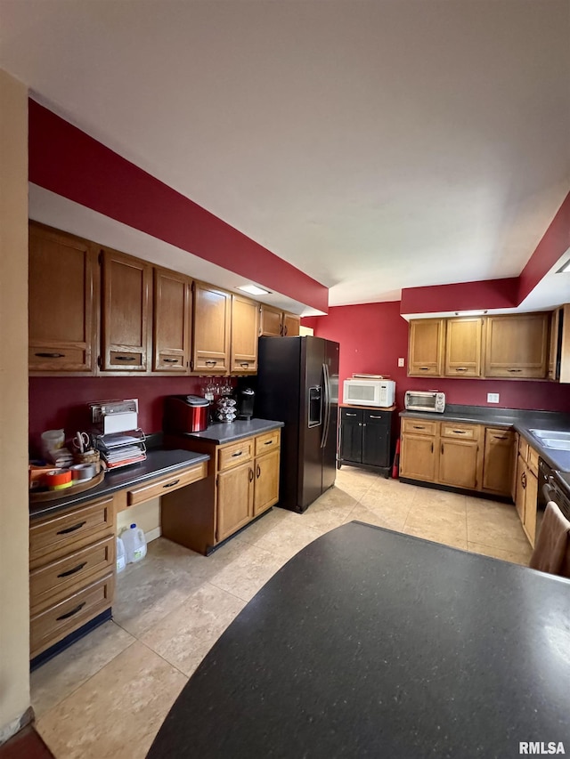 15 Elmo Dr, Macomb, IL 61455 - kitchen featuring white microwave, black fridge with ice dispenser, dark countertops, and brown cabinetry