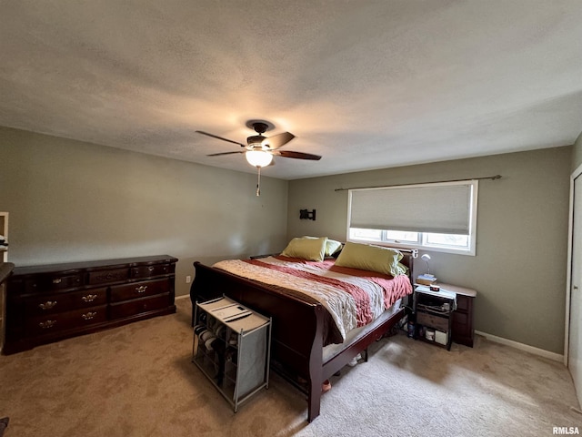 15 Elmo Dr, Macomb, IL 61455 - bedroom featuring light carpet, ceiling fan, and a textured ceiling
