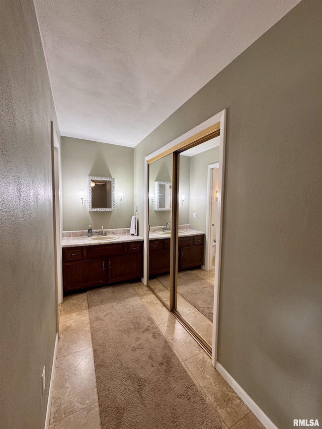 15 Elmo Dr, Macomb, IL 61455 - bathroom with vanity, a textured ceiling, and tile patterned floors