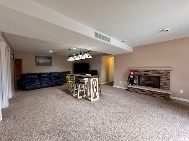 15 Elmo Dr, Macomb, IL 61455 - carpeted living room with a fireplace and recessed lighting