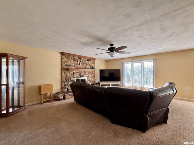 15 Elmo Dr, Macomb, IL 61455 - carpeted living room with a textured ceiling, a ceiling fan, and a stone fireplace