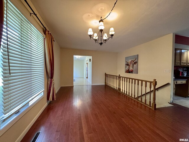 15 Elmo Dr, Macomb, IL 61455 - empty room with a chandelier and hardwood / wood-style floors