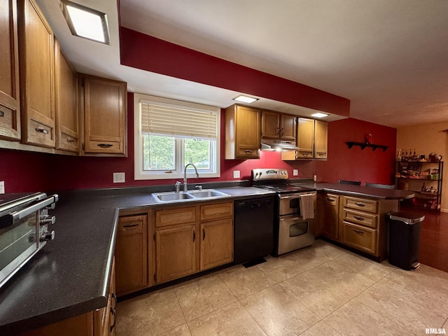 15 Elmo Dr, Macomb, IL 61455 - kitchen with range with two ovens, under cabinet range hood, a peninsula, black dishwasher, and dark countertops