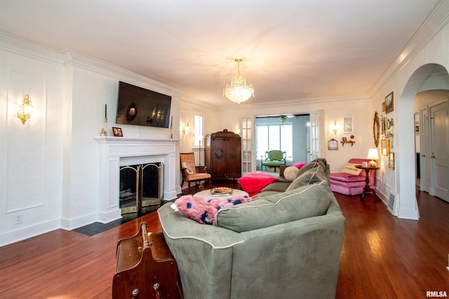 3316 N Biltmore Ave, Peoria, IL 61604 - living room featuring wood finished floors, arched walkways, ornamental molding, a fireplace with flush hearth, and ceiling fan