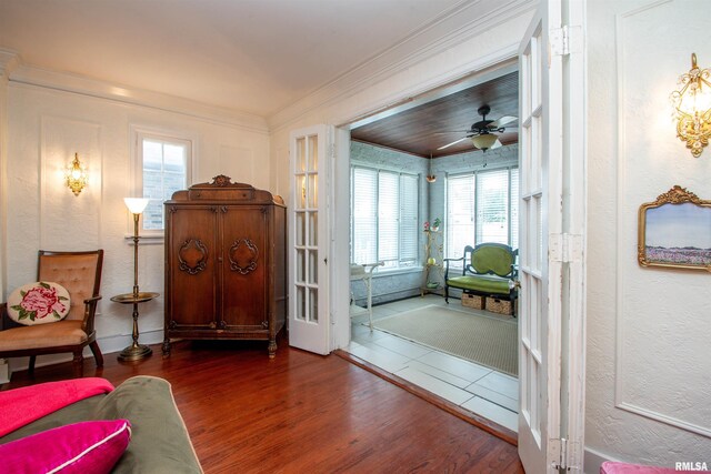 3316 N Biltmore Ave, Peoria, IL 61604 - living area with wood finished floors, arched walkways, crown molding, a fireplace with flush hearth, and a chandelier