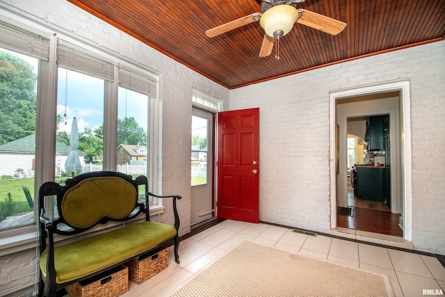 3316 N Biltmore Ave, Peoria, IL 61604 - foyer entrance with light tile patterned floors, a ceiling fan, wooden ceiling, and brick wall