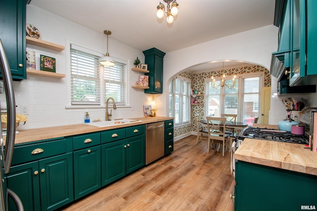 3316 N Biltmore Ave, Peoria, IL 61604 - kitchen with butcher block countertops, stainless steel appliances, open shelves, and a chandelier