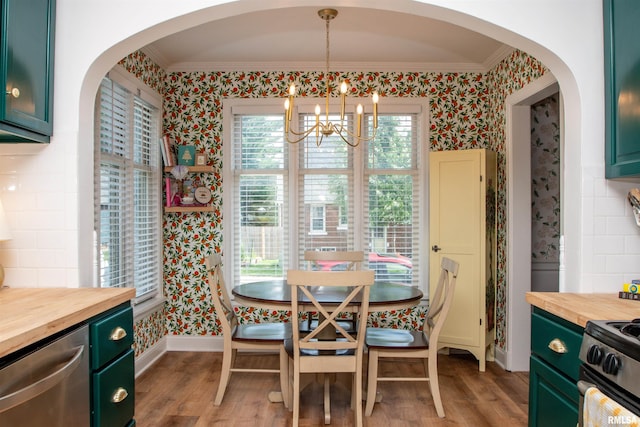 3316 N Biltmore Ave, Peoria, IL 61604 - dining room featuring wallpapered walls, crown molding, a chandelier, arched walkways, and light wood-style floors