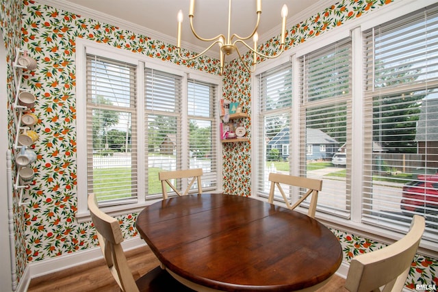 3316 N Biltmore Ave, Peoria, IL 61604 - dining space featuring wallpapered walls, a chandelier, ornamental molding, and wood finished floors