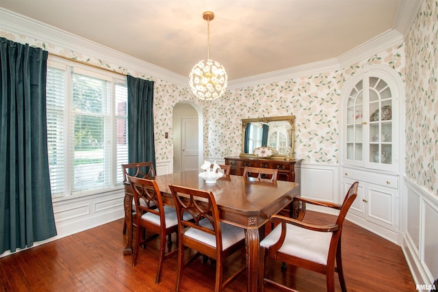 3316 N Biltmore Ave, Peoria, IL 61604 - dining area featuring arched walkways, wallpapered walls, dark wood finished floors, a wainscoted wall, and a chandelier