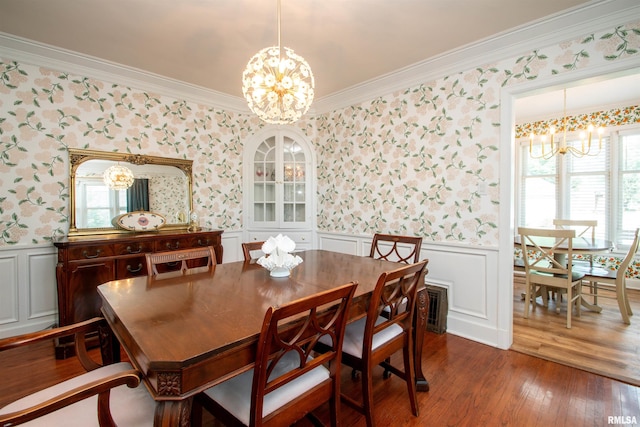 3316 N Biltmore Ave, Peoria, IL 61604 - dining area featuring a chandelier, wallpapered walls, crown molding, wainscoting, and dark wood-style flooring