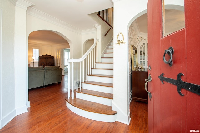 3316 N Biltmore Ave, Peoria, IL 61604 - stairway featuring wood finished floors, ornamental molding, and arched walkways