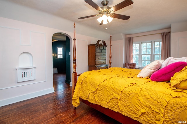 3316 N Biltmore Ave, Peoria, IL 61604 - bedroom featuring arched walkways, wood finished floors, multiple windows, and a ceiling fan
