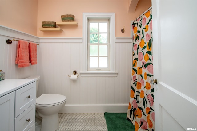 3316 N Biltmore Ave, Peoria, IL 61604 - bathroom with a wainscoted wall, vanity, a shower with shower curtain, and tile patterned floors
