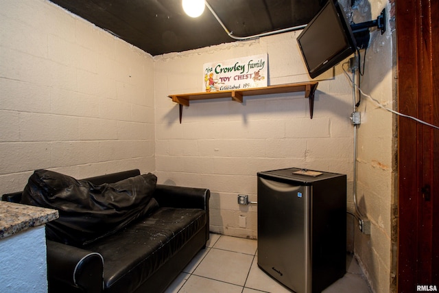 3316 N Biltmore Ave, Peoria, IL 61604 - laundry area with light tile patterned flooring and concrete block wall