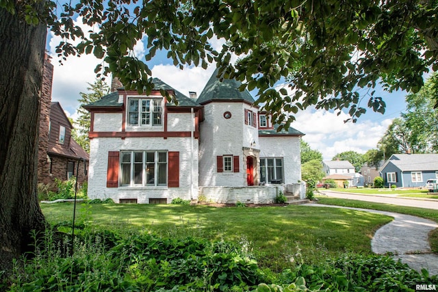 3316 N Biltmore Ave, Peoria, IL 61604 - victorian home with brick siding, a front lawn, and a chimney