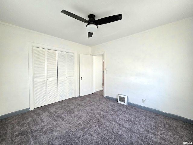 1507 W Circle Rd, Peoria, IL 61604 - unfurnished bedroom with dark carpet, a closet, and a ceiling fan
