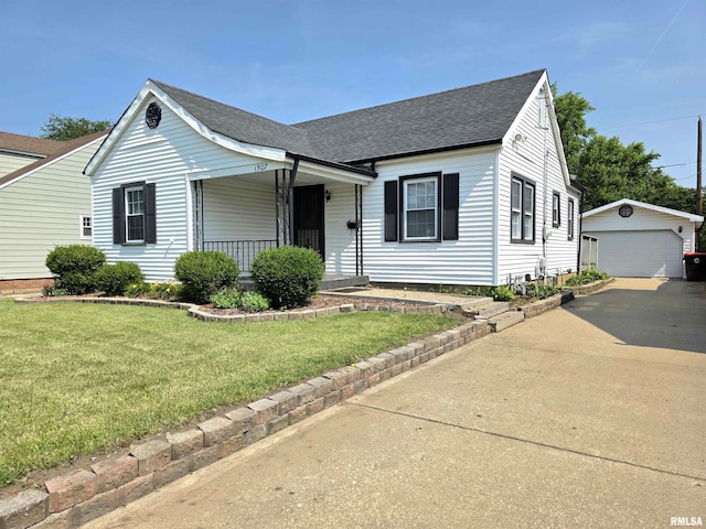 1507 W Circle Rd, Peoria, IL 61604 - view of front of property featuring an outbuilding, a shingled roof, covered porch, a front yard, and a detached garage