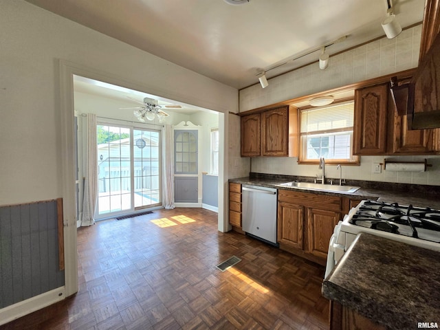 1507 W Circle Rd, Peoria, IL 61604 - kitchen featuring dishwasher, dark countertops, track lighting, and healthy amount of natural light