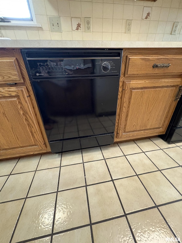 502 W Crestwood Dr, Peoria, IL 61614 - kitchen featuring black dishwasher, brown cabinets, light tile patterned floors, decorative backsplash, and light countertops