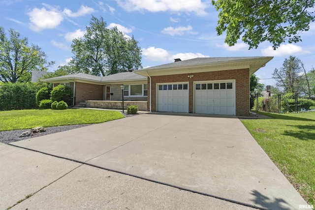 502 W Crestwood Dr, Peoria, IL 61614 - view of front of home featuring an attached garage, a front lawn, brick siding, and driveway