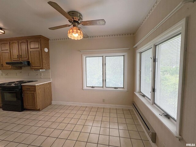 502 W Crestwood Dr, Peoria, IL 61614 - kitchen featuring black range with electric stovetop, under cabinet range hood, a baseboard heating unit, backsplash, and light countertops