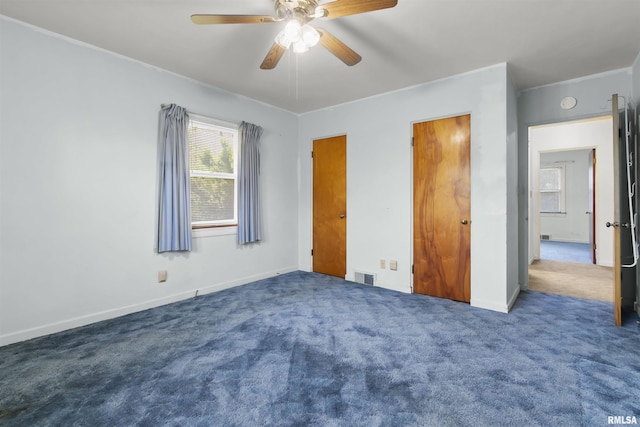 502 W Crestwood Dr, Peoria, IL 61614 - unfurnished bedroom featuring carpet floors and a ceiling fan