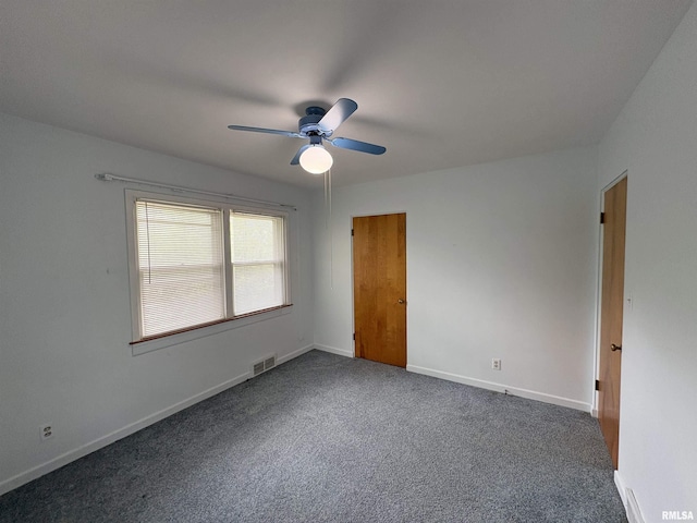 502 W Crestwood Dr, Peoria, IL 61614 - unfurnished bedroom with dark colored carpet and a ceiling fan
