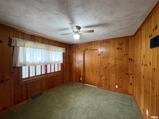502 W Crestwood Dr, Peoria, IL 61614 - unfurnished room featuring a ceiling fan, carpet floors, and wooden walls